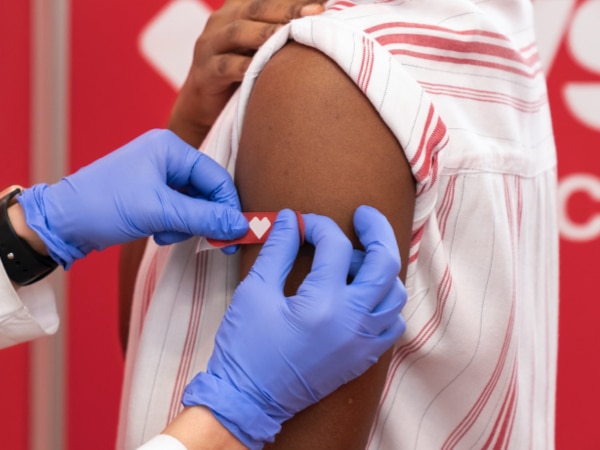Arm of patient with CVS bandage being applied after receiving vaccination